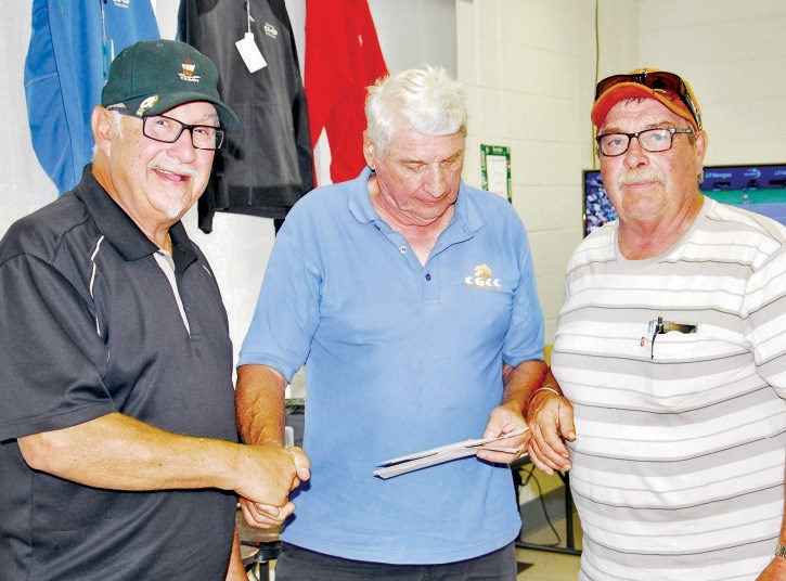 Glen Leson (left) and Garry Mackisey (right) won the first flite of the men’s division of the seniors’ golf tournament. Making the presentation was Steve Borys.