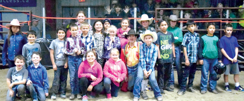 This is a photograph of the group of youngsters who participated in the wild pony races held during Saturday’s rodeo. They were photographed with the bull fighter, who while dressed in colourful garb, is the man who attempts to take the bull’s attention away from the rider.