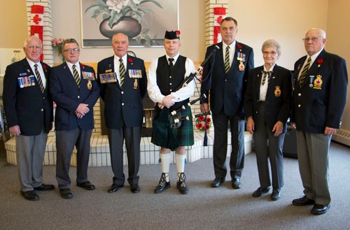 Reagan Miller (centre) is joined by members of The Royal Canadian Legion Carlyle Branch at the Moose Mountain Lodge following an early Remembrance Day ceremony at the Lodge. from left to right: Jack Wilson, John Voutour, John Pott, Reagan Miller, George Anderson, Audrey Young, and Lyle Basken.