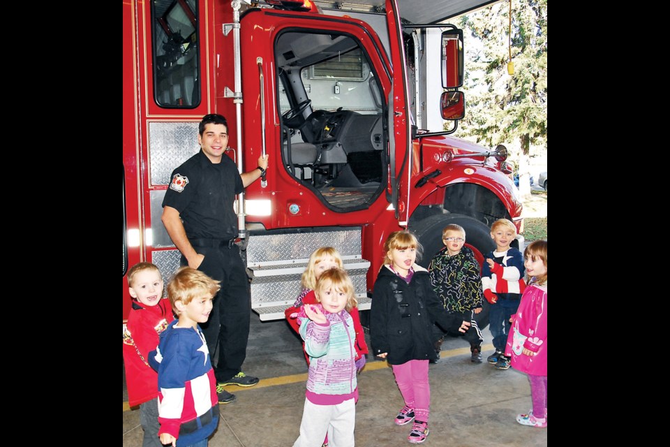 Guided tour: Corey Perrin, the Canora fire department’s secretary-treasurer, was one of the fire fighters giving a guided tour of the fire hall and a close-up look at the fire trucks when the students from Canora Kidspace visited the fire hall on Thursday during Fire Prevention Week. From left, among the students participating in the tour were: PJ Krueger, Knox Oswald, Priah Wolkowski, Courtlyn Heshka (back), Lilith Shewchuk-Gilson, Cameron Sznerch, Kruze Oswald and Sage Nehaj.