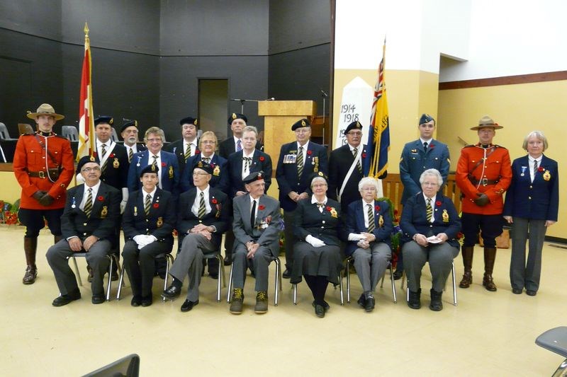 The Norquay Remembrance Day service was held November 11 at the Communiplex. Among the persons taking part in the service, from left, were: Cst. Brian Holmes of the RCMP, Jerimi Korpusik, (flag bearer), George Grant, Donna Lulashnyk, Neil Cox, Vi Skogan, Brad Knutson, Kathy Ostafichuk, Allan Hodgeson of Tisdale (guest speaker for banquet), Ken Paluck (flag bearer), Anthony Turta of Cold Lake, Alta., Cst. Dana Harris of the RCMP and Laura Dahl (president of Norquay Legion), and (front) Lenny Abbott, Genoveve Galay, Dwayne Johnson, Joe Malonowich, Denise McGonigal, Anne Markewich and Dorothy Griffith.