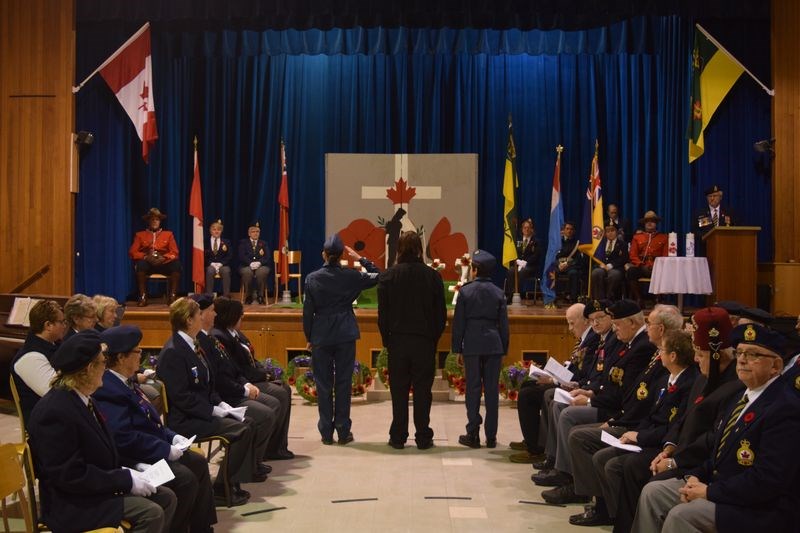 The Kamsack Remembrance Day service was held in the Victoria School gymnasium where the front of the room was decorated with a cenotaph for the laying of wreaths and a Remembrance Day mural was a backdrop for the colour party.