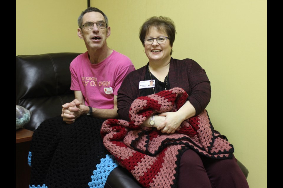 Brad Bolton, left, presented lap blankets to Christine Stephany from the Estevan Regional Nursing Home. Missing: Pauline Tuchscherer.