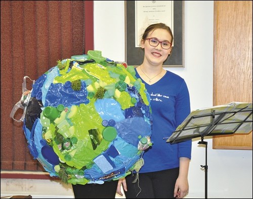 Natalyna uses a statement art piece as part of her presentation on littering. It is made up completely of litter she found within the town of Battleford.