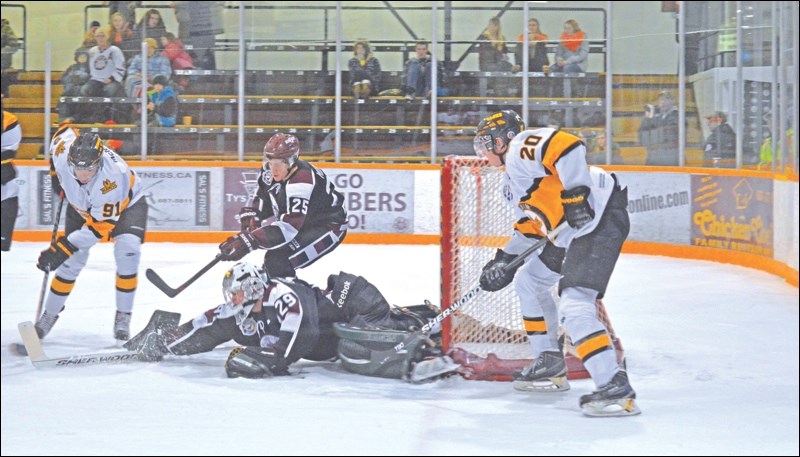 Bombers netminder Zac Robidoux blocks Zach McNeill’s attempt to move the puck as Bombers defenceman Pierre-Luc Morin and Hawks forward Reily McIntosh try to intervene. Robidoux has since temporarily left the team to try out for Team West for the World Junior A Challenge.