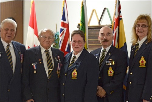 Members of Royal Canadian Legion Branch No. 9 pose in front of the flag. In the photo are Bob Tannahill, Alex Kovar, Arleen Engedahl, Tim Popp and Esther Delainey. Photos by Dustin Saracini