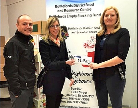 Stuffing the Stockings — Danielle Gignac and Norman Hochbaum from Farm Credit Canada making a cash donation of $1,255.15 from their annual Drive Away Hunger Campaign to the Empty Stocking Fund. Accepting the donation is Executive Director Erin Katerynych. Photo submitted