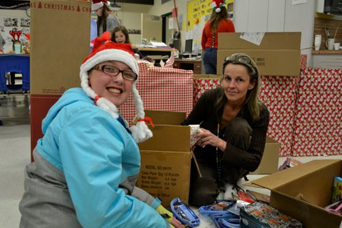 Carlyle's The Bargain Shop! and Cornerstone Family and Youth partnered up this Christmas to spread a little Santa to local youth. Here, (l-r) CFY Girls Group member and volunteer Kaysha Turner and The Bargain Shop! Manager, Shannon MacLeod team up to sort and wrap gifts at the CFY Girls Group Wrap party at Carlyle's Gordon F. Kells High School on Tuesday, Dec. 15. “Thank you to everyone for making this a success,” says MacLeod. “We're so happy to focus on our area families at Christmastime and we plan to do it again next year.”