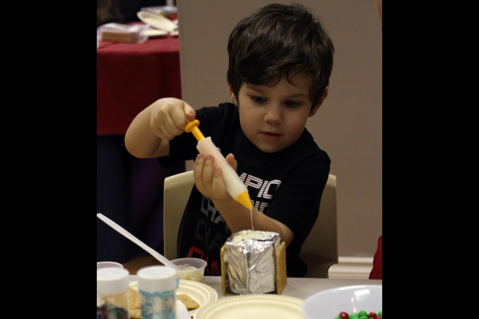 Kade Kawa gets ready for Christmas by making a tasty new decoration, a gingerbread house. Kids had the opportunity to make gingerbread houses at the Family Resource Centre.
