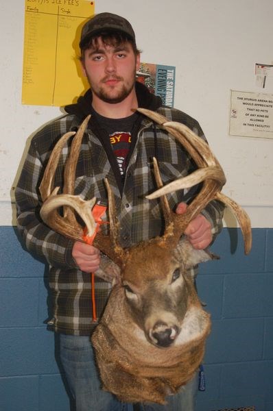 Mitchell Meroniuk brought in a big white-tailed deer trophy to be measured by Blair Mitchell.