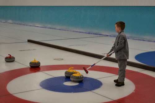 Six-year-old Hunter Clark of Roblin, Manitoba takes to the ice at Carlyle's Boxing Day Bonspiel on Dec. 26, 2015. The novice curler said his favourite part of the sport was “sweeping.”