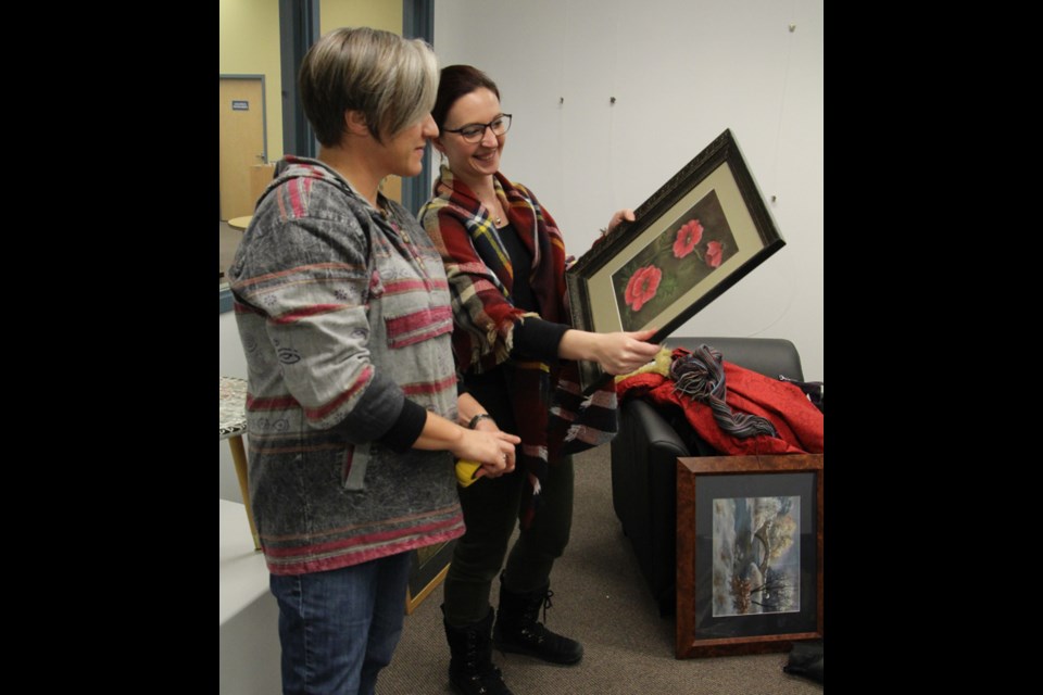 Tonia Vermette (left) and Meagan Richards look at some of the artwork while setting up the 50th anniversary show “Past, Present and Future” hosted at the community pARTners gallery at the Yorkton Public Library. The arts council was overwhelmed by the amount of support from local artists for the show, demonstrating the strength of the arts community in the city. The show runs until February 12, with an artist reception on January 17 at 2:00 p.m.
