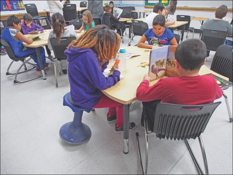 Grade 4 students in Patti Lawrence’s classroom take part in silent reading time after recess. Theirs is one of two pilot classrooms in Flin Flon with active seating options such as a rocking chair, seen at left, and the bouncy hokki stool, which allow students to move while they learn.
