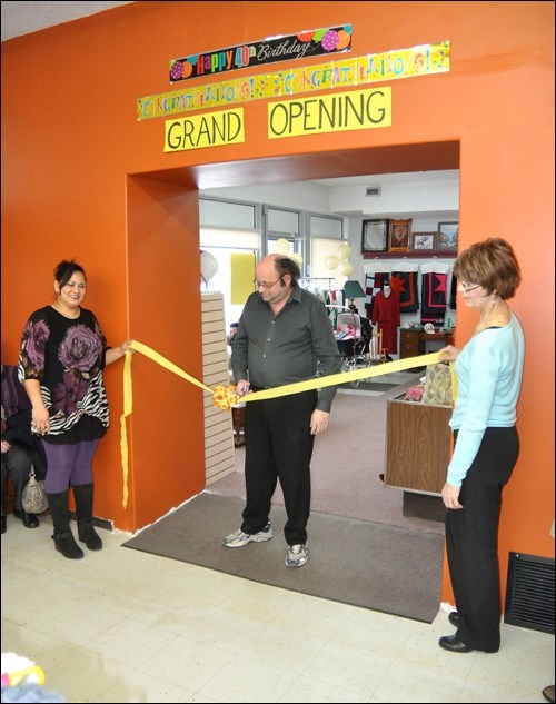 Staff member James Fielding cut the ribbon as employee Marcela Castilo and store manager Sharon Janzen held the tape. Photos by John Cairns