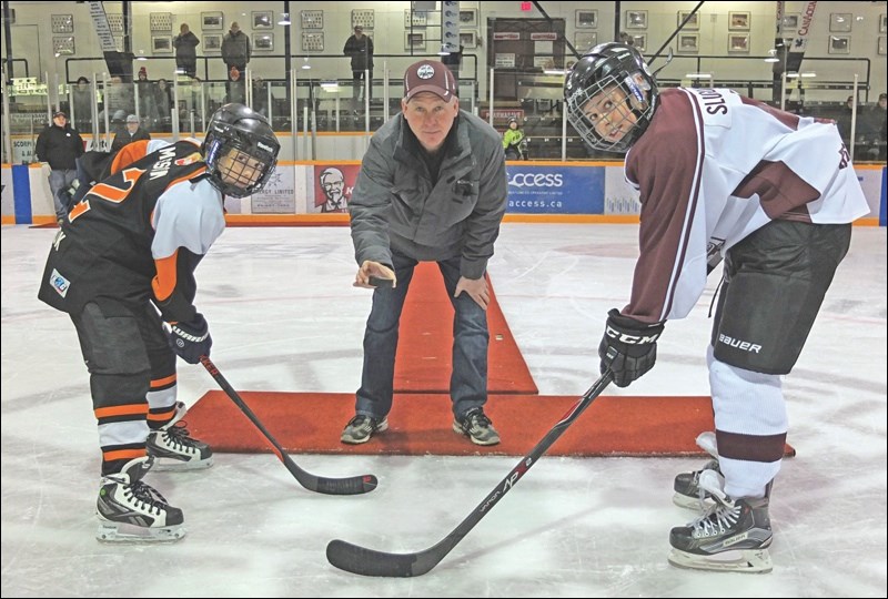 Todd Quinn, father of Teagan Quinn, dropped the puck at a ceremonial faceoff during the newly christened Teagan Quinn Memorial Peewee Tournament last weekend at the Whitney Forum and Creighton Sportex. Taking the faceoff were Seth Massan (left), captain of the Thompson King Miners, and Owen Slugoski, captain of the Flin Flon Kinsmen Bombers. Teagan, who passed away in 2014, played his way through the Flin Flon minor hockey system and made many friends along the way.