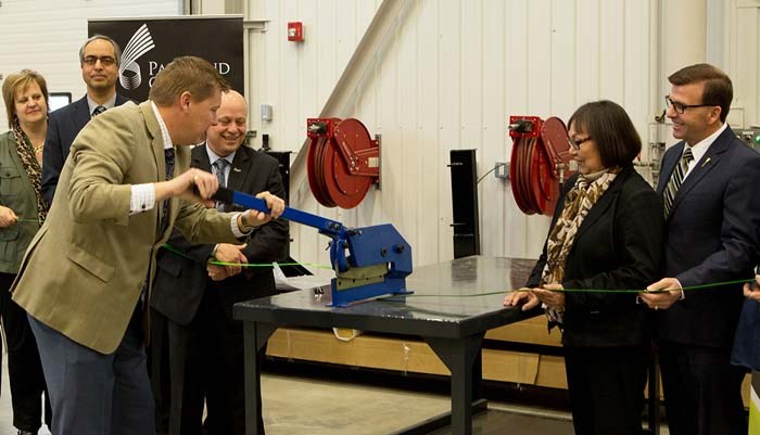 Advanced Education Minister Scott Moe used a shear to cut a green metal “ribbon” at the the official Grand Opening of the Trades and Technology Centre in October.