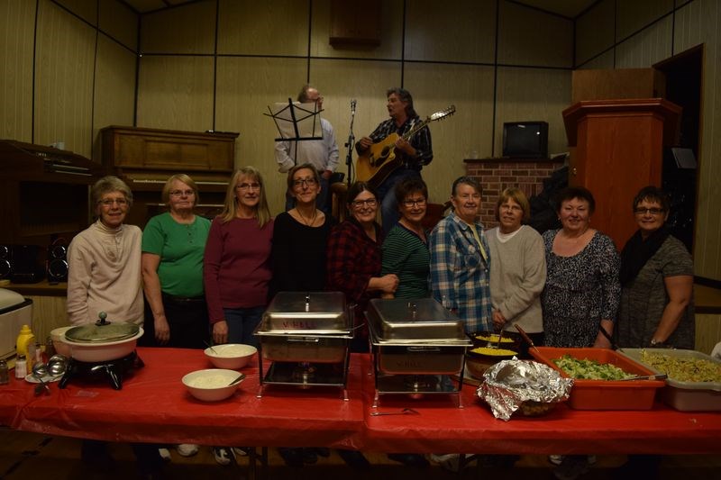 Among the volunteers who prepared the ham-and-perogy supper served at the Veregin hall on January 10, from left, were: Sarah Kuzma, Joyce Musselman, Adeline Horkoff, Deb Bates, Shelley Chernoff, Wendy Chernoff, Phyllis Holodniuk, Faye Bloudoff, Nadia Reibin and Ruby Dubasov. On stage at back were Roger Moore and Rick Chernoff.