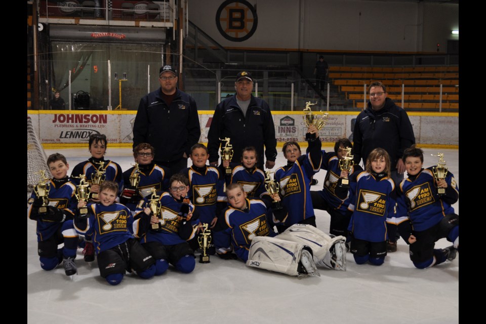 The Weyburn AM 1190 atom Blues celebrate their A-side finals win in the Estevan Atom Tournament on Sunday at the Civic Auditorium.