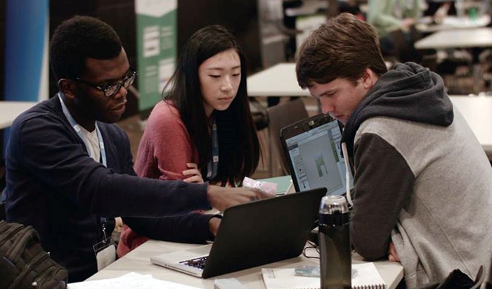 Corey Hickson, Uchi Uchibeke, and Zoe Mao working on their project.