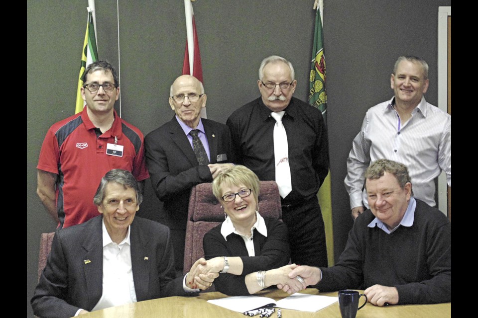Unity mayor Sylvia Maljan with officials of Soneera Water Canada Ltd. as an agreement is signed for the firm to develop a wastewater treatment system for the town. Photos submitted