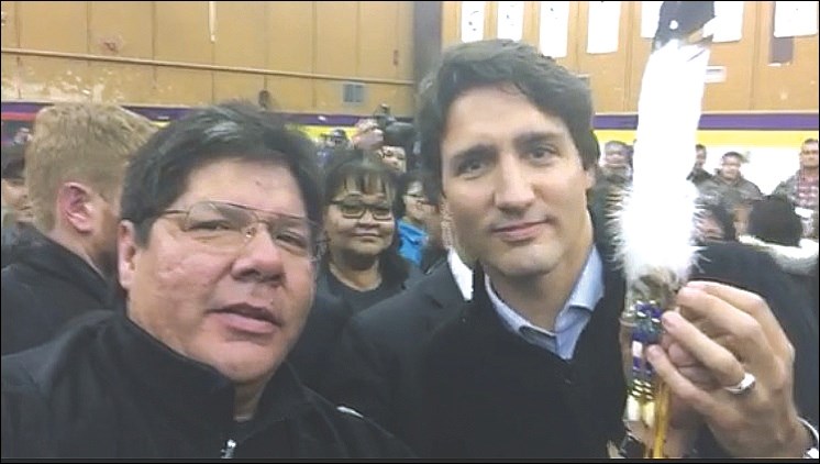 Tom McDermott presented an eagle feather, a symbol of strength and courage, to Justin Trudeau following the prime minister’s speech to residents of La Loche.