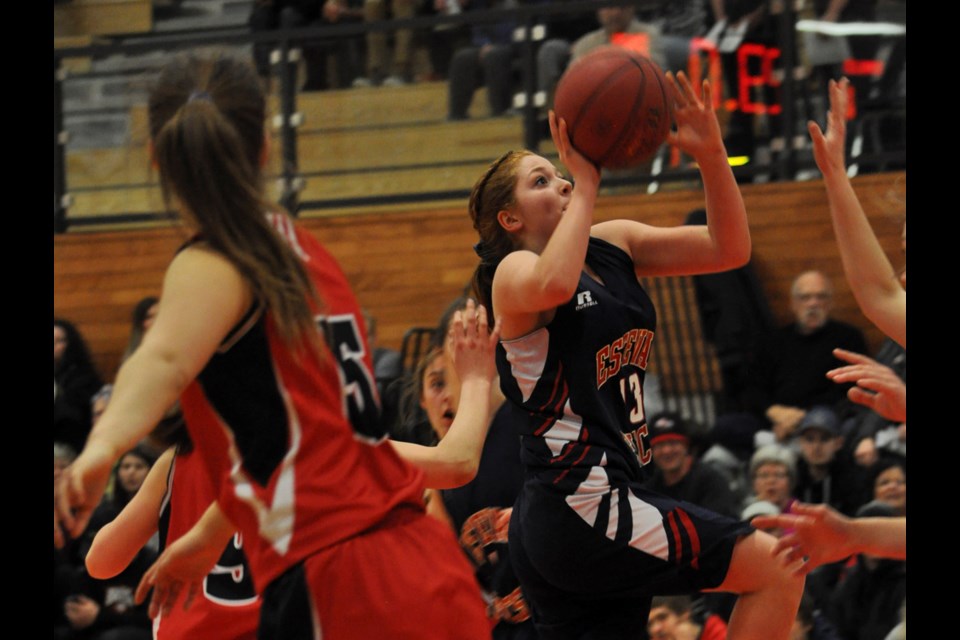 Elec Sammy Wade fights through a strong Eagles' defence to score a first-half basket.
