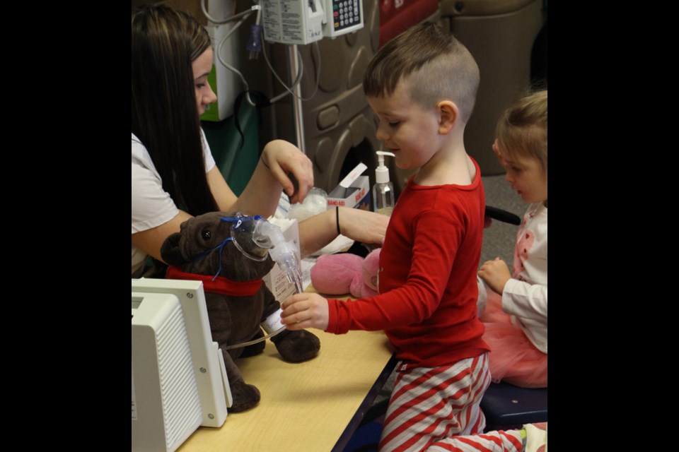 Front Page Photo – Cohen Laird gets one of his good friends checked up by one of the nursing students at the Teddy Bear Bash. The goal of the event was to get kids more comfortable with hospitals and medicine through interacting with nursing students from the Parkland College who are enrolled in the nursing program in partnership with the University of Saskatchewan. See more in related story "Nursing students take the scare out of care".