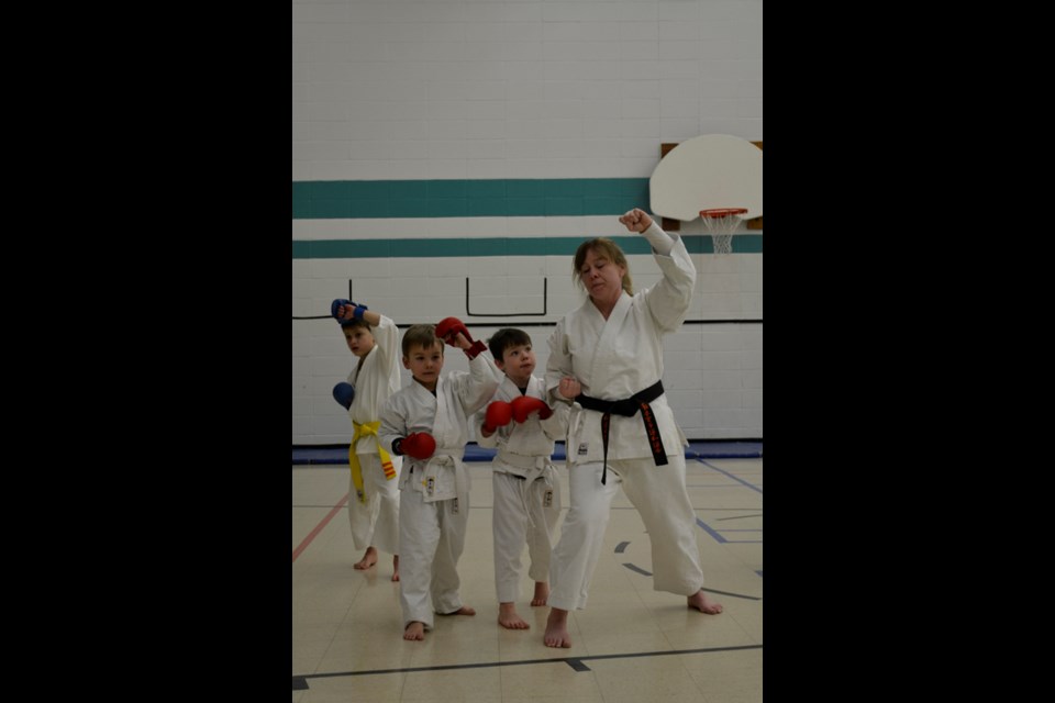 The Moose Mountain Wado Kai Karate Club's members are from throughout the southeast area of Saskatchewan and are made up of competitors of all ages. Here, Sensei Cara McNair coaches some of the club's youngest members in some martial arts moves.