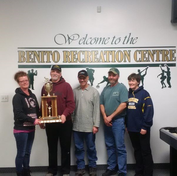 Kim Pierce, left, presented the Swan Valley Credit Union trophy to the Brad Knutson rink of Norquay, which was the first event winner of the Benito mixed bonspiel. Curling with Knutson, the skip, were: Richard Johnston, third; John Knutson, second, and Vi Knutson, lead.