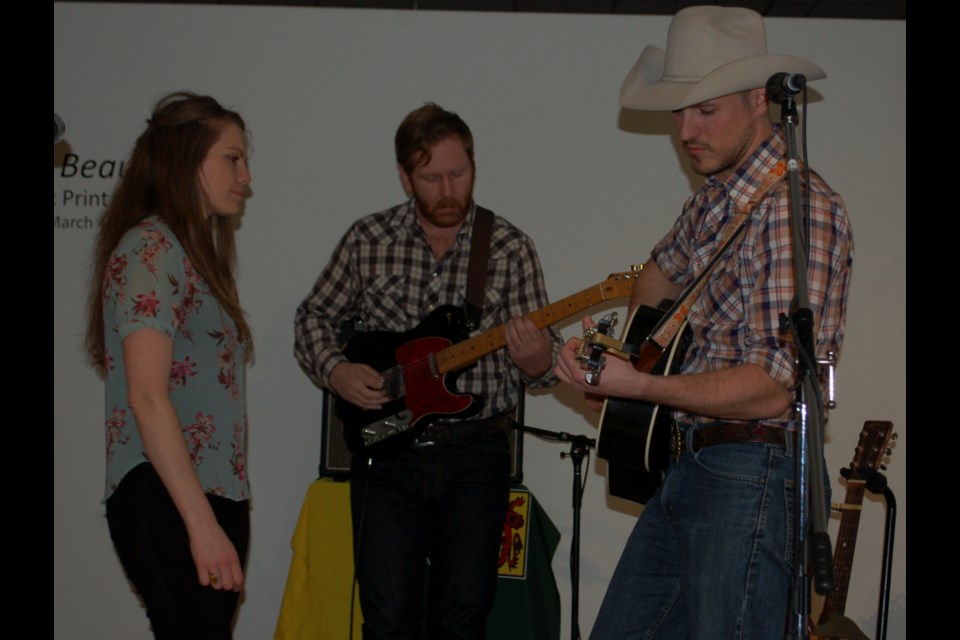 Belle Plaine and Blake Berglund with guitarist Bryce Lewis in the background. The couple were featured in the EAGM's After Dark concert series on Friday.