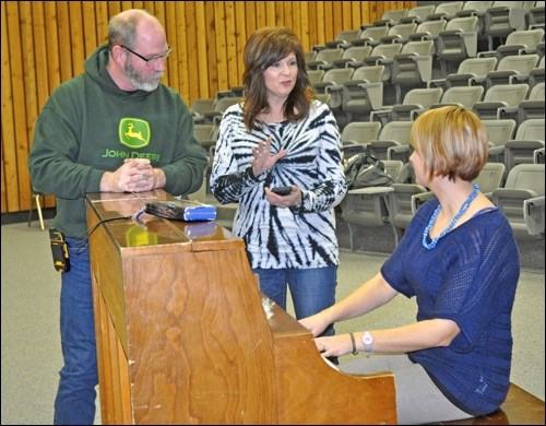 Dave Tupling, Cammie Vany and Sarah Whitbread share ideas at the piano during an organizational meeting aimed at fostering collaboration and inspiration. Photos by Jayne Foster