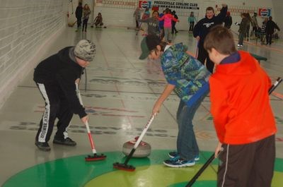 Michael Carlson, left, and Calan Hort swept a rock into the rings during the Preeceville School bonspiel on February 5.