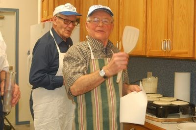 Peter Predy, left, and Roy Fairburn helped prepare and serve pancakes at the Shrove Tuesday pancake supper in Preeceville on February 9.