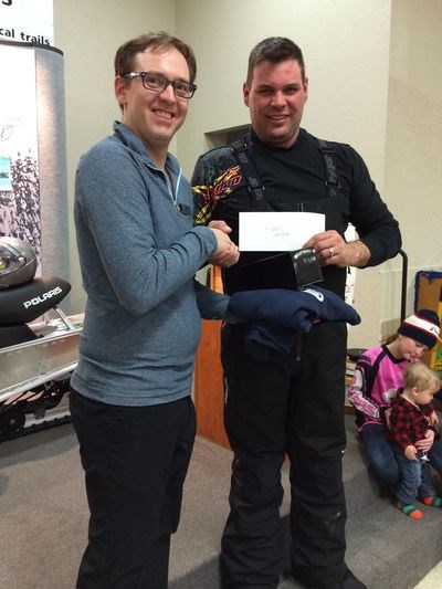 Kelly Minky, right, was the rider who carried the second-place highest hand at the Kelvington Trail Blazer snowmobile derby on February 6. Bart Hartl made the presentation.