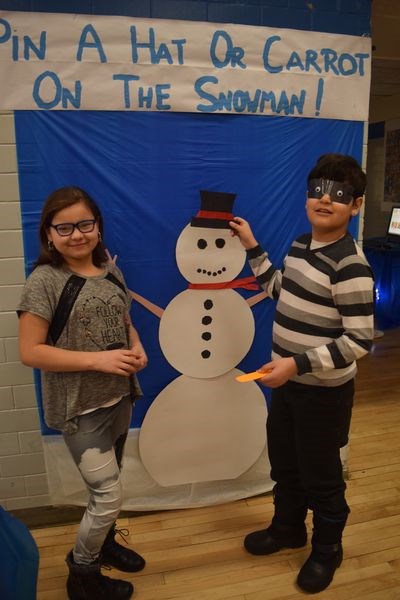 Tyra Keshane and Germaine Keshane operated a booth that asked contestants to pin a hat, or a carrot, onto a painted snowman.