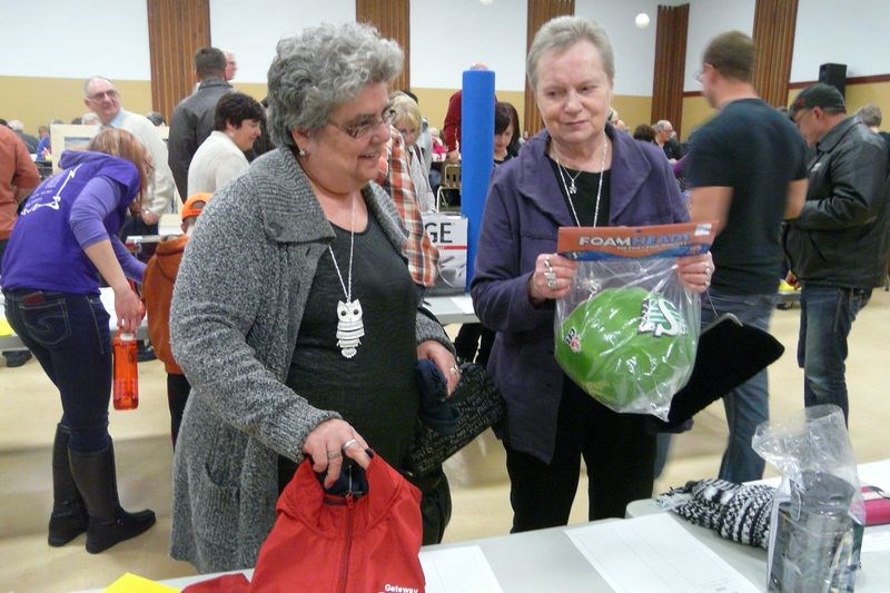 Margaaret Menzies, left, and Kathy Ostafichuk were looking for items to bid on at the Norquay Kin Club’s Telemiracle auction held February 27 at the Communiplex.