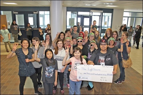 The Lighthouse accepts a donation from the North Battleford Comprehensive Lighthouse Me to We group. Photos submitted
