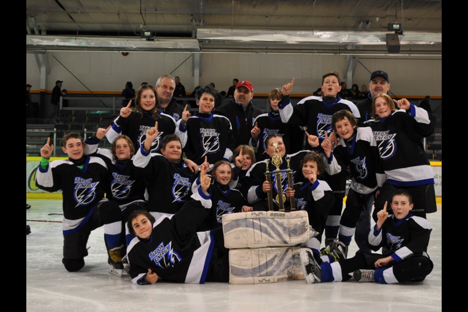 The Estevan Tarpon Energy peewee Storm celebrate their SEMHL title at the Civic Auditorium on Sunday.