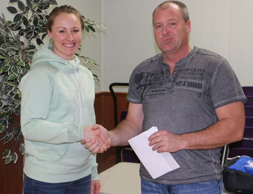 Bree Ryan accepts a cheque presented to the Arcola Day Care by Optimist member Randy James. “I think the town would be very different without the fundraising we do together,” Optimist President Blake Brownridge said.