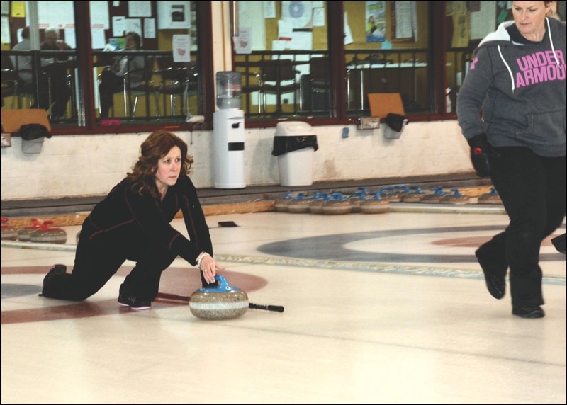 Dodie Johnston of the Lori Salahub rInk is all concentration as she aims a stone during the ladies’ bonspiel held last weekend at the Uptown Curling Club.