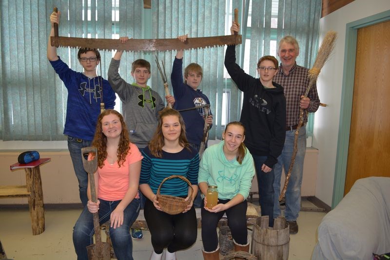 The Grade 8 class social studies students took up the challenge to make something that would have been used by the pioneers of this area. From left were: Carson Barteski, Jessie Biletski, Kristian Norum, William Hauber and Cec Machnee (teaher); and front, Jordelle Lewchuk and Rebekha Thomas. Ally Sleeva was sitting on the bench that Jordelle Lewchuk made.