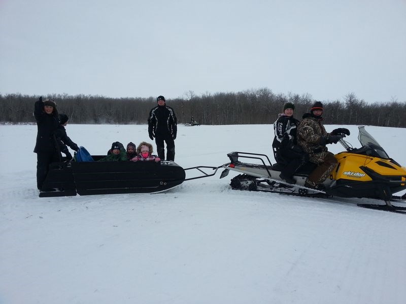 Families from the area took advantage of the fun family day provided by the Roughrider Snowmobile Club on February 21 to have some outdoor fun. From left, were: Kent Scheller, Alecia Shuba, Wyatt, Abby, Allie, Rob, Becky and Scott Scheller.