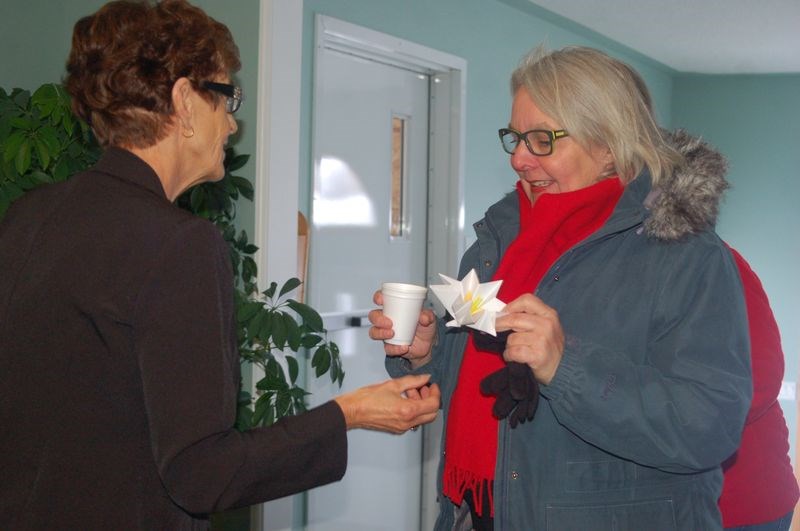 Carole Hauber welcomed Aileen Lubiniecki with a glass of lemonade and a paper jasmine flower at the beginning of the Sturgis World Day of Prayer Service on March 4.