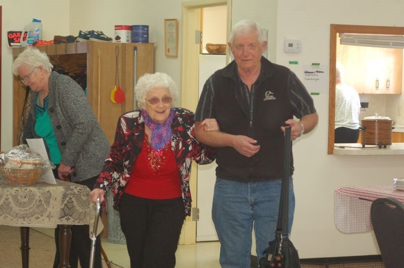 Gladys McDougall was escorted by Larry Skogen into the rock-a-thon fundraiser at the Sturgis READ Club on March 16.