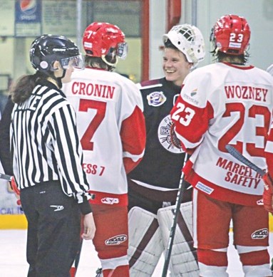 Bombers rookie goalie Brenden Newton was all smiles as he shook hands with Red Wings blueliner Josh Cronin after Flin Flon’s series-ending victory. Also pictured are Red Wings forward Jacob Wozney and lineswoman 
Krista Funke.