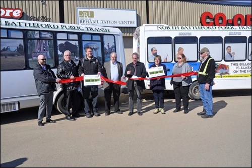 The ribbon cutting, left to right, planner Devin MacAuley, councillors Greg Lightfoot and Ryan Bater, Transit Manager Al Love, Mayor Ian Hamilton, Councillor Cathy Richardson, transit board member Debbie Logan and driver Walter Schliemann. Photos by Jayne Foster