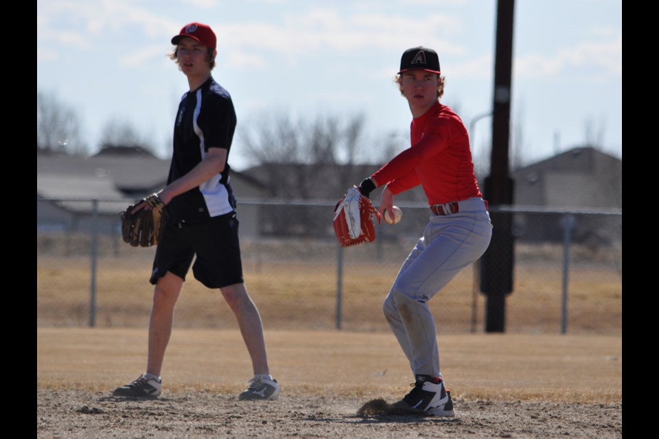 Dahlyn Klassen sets up to make a throw to first base during a Twins' tryout on Saturday.
