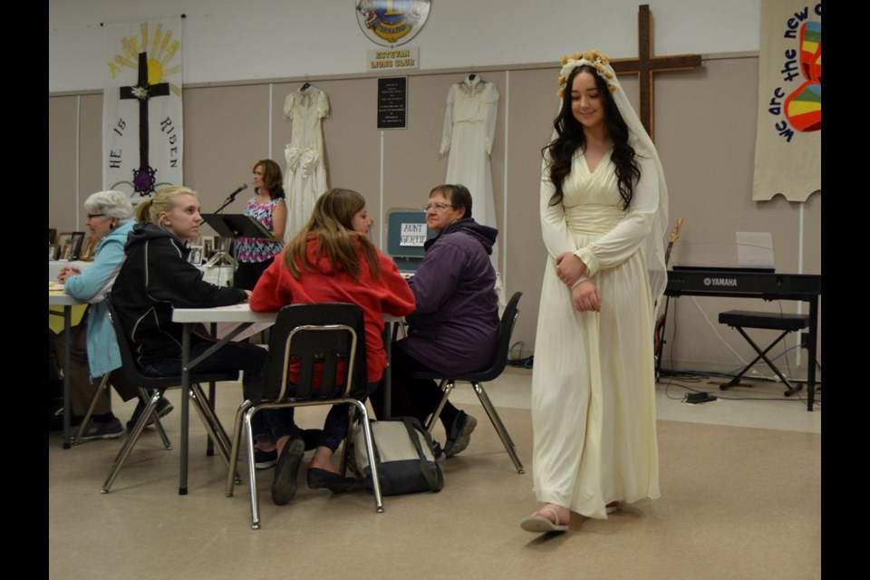 Breanne Shulda models one of the many wedding dresses showcased as part of the Faith Lutheran Church's wedding dress gala.