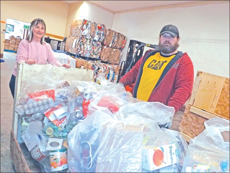Recycling Centre administrator Deb Odegaard and employee Wayne Freund move a cart stocked with bags of recyclables. The centre enjoyed its third-most successful year to date in 2015.