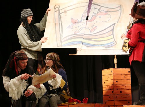 Jaime (Cassidy Roy) shows potential new flag drawings to a fellow pirate (Carter Branyik-Thornton) including one of a unicorn with wings flying over a rainbow. Her fellow pirate is unimpressed calling it a Pegasus with a horn and suggests they come up with something like a kraken or shark instead.